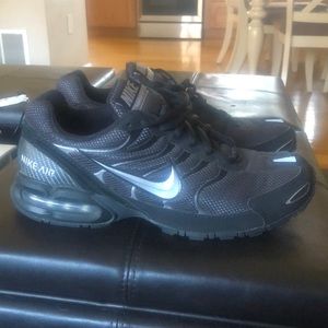 Nike Torch 4- Like brand new. Worn ONCE. Black and Silver. NO marks, Wear/tear